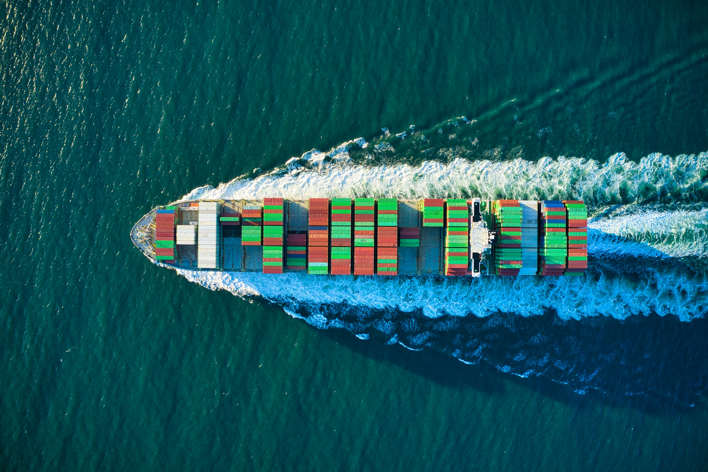 Aerial view of a cargo vessel and its wake